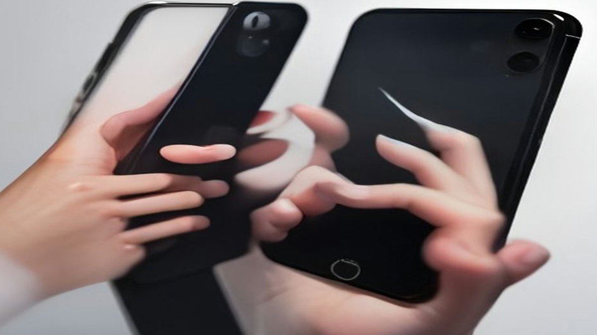 Person holding cracked iPhone Duo.