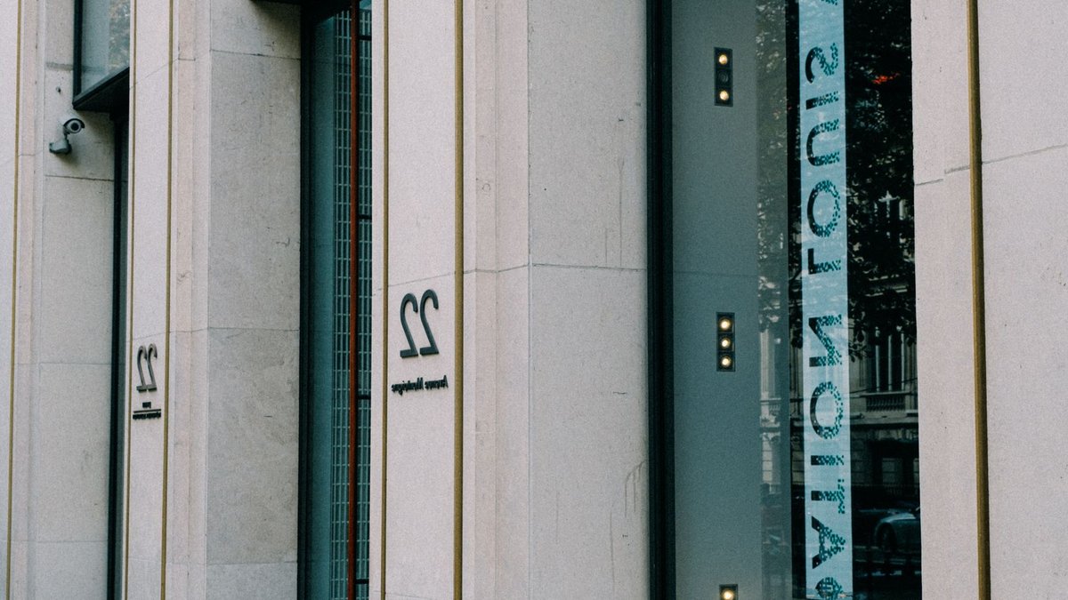 The sleek exterior of a modern luxury store with large windows and minimal design.