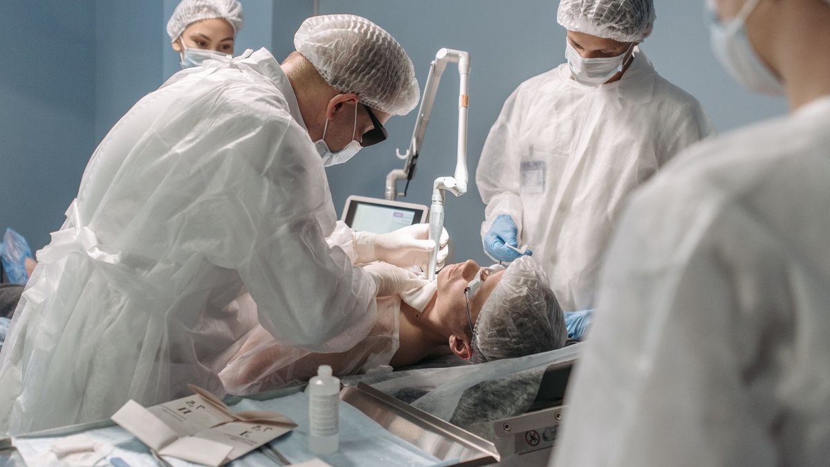 Ireland-based robotics firm pivots to US Team of surgeons conducting surgery with precision in a modern operating room setting.
