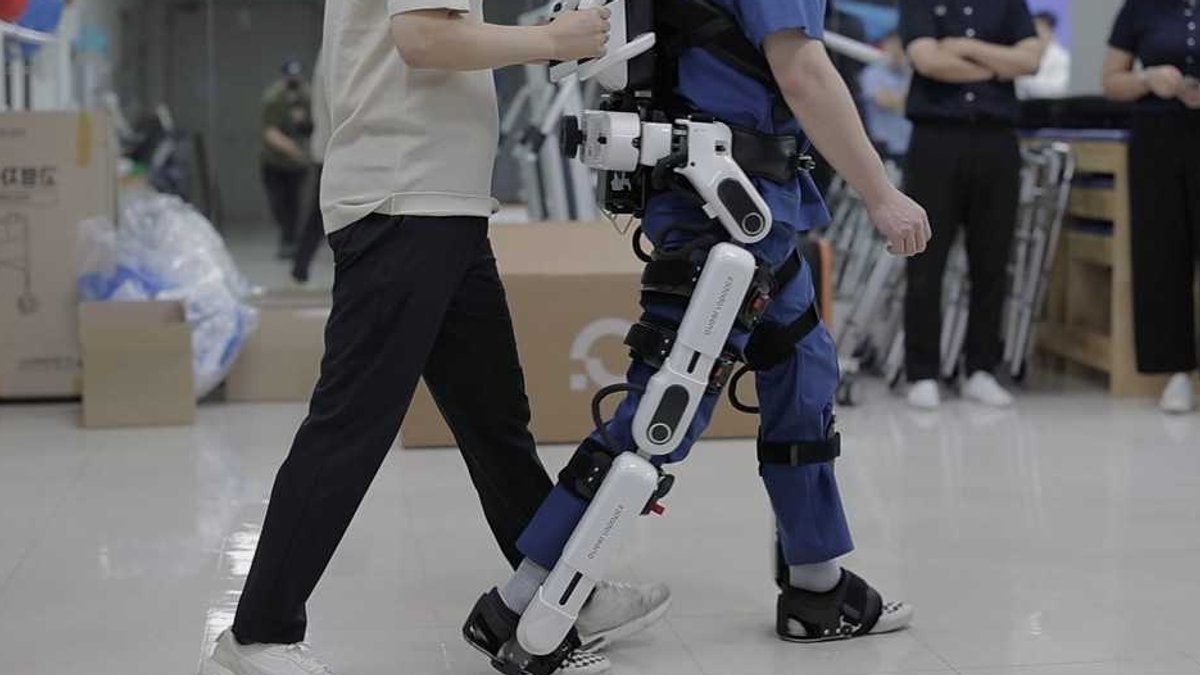 A recipient of the Posco 1% Sharing Foundation's advanced mobility assistance program practices walking with a robotic exoske