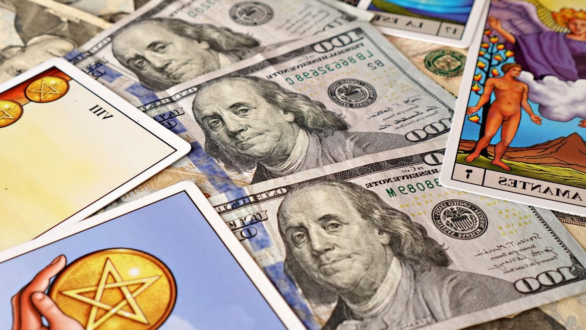 American Express cuts 3,500 jobs in restructuring Combination of tarot cards and U.S. dollar bills symbolizing financial prosperity and mysticism.