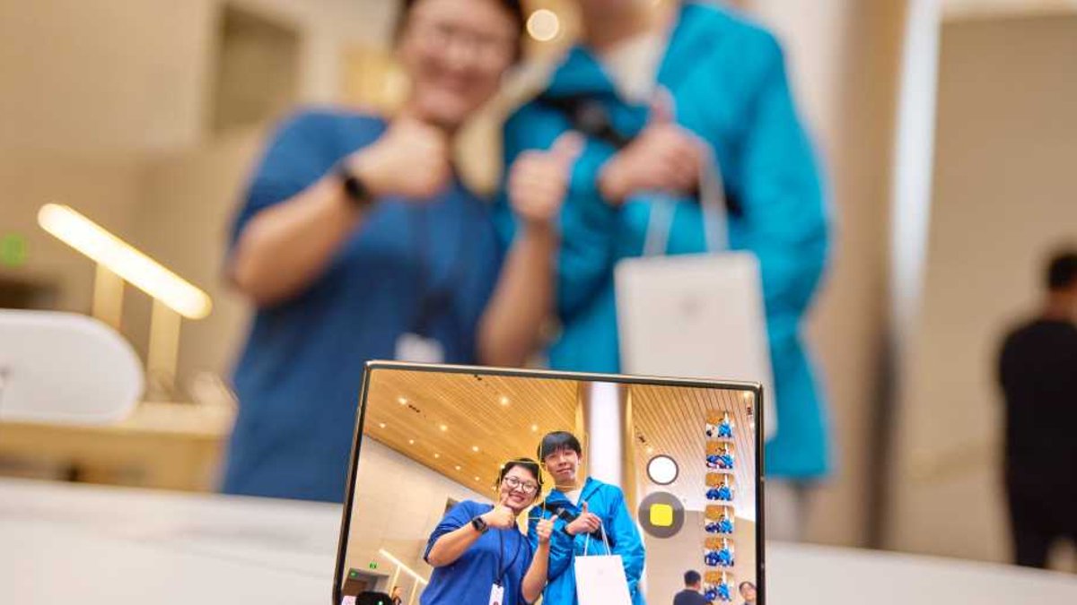 iPhone Duo launch sparks lines despite app shortage An iPhone Duo showing two people on its display.