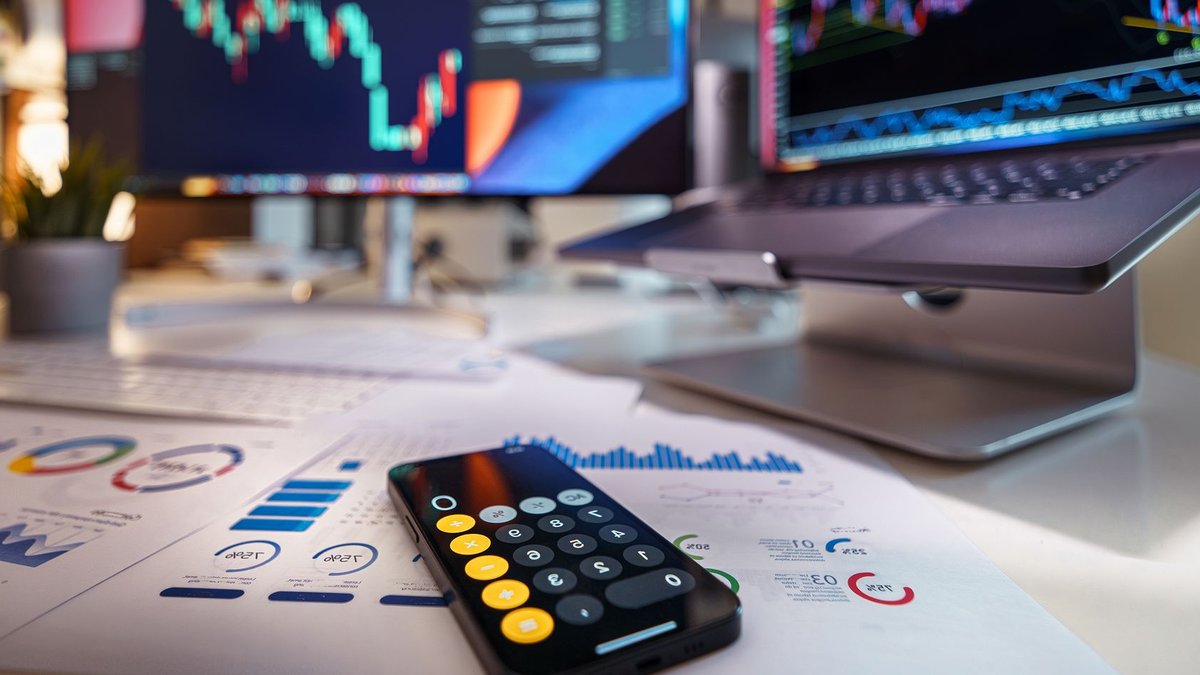 Modern workspace showcasing financial analysis with digital charts and reports.