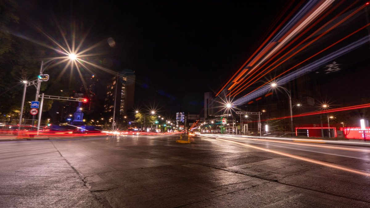 Dynamic long exposure of traffic light trails at night in downtown Mexico City.