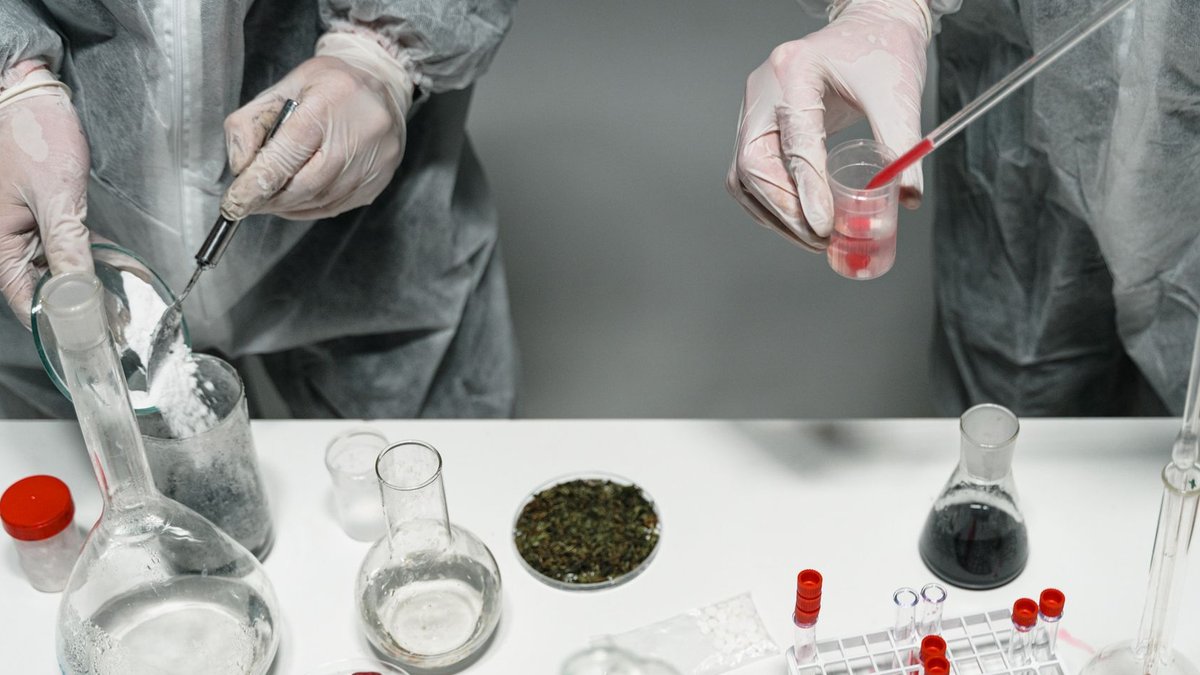 FDA approves GSK’s bepirovirsen for chronic hepatitis B Scientists in protective gear conducting experiments in a modern laboratory setting.