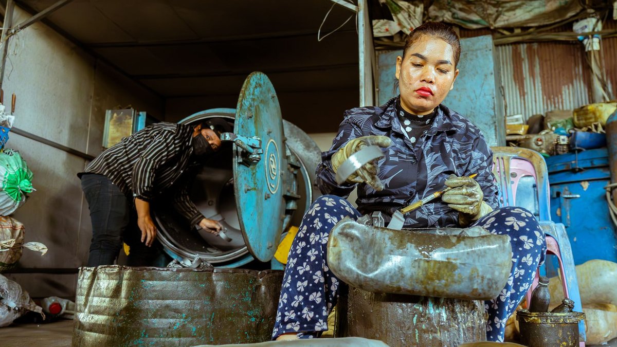 EU Scrap Rules Threaten India's Recycling Trade Workers in a recycling plant sorting materials, emphasizing teamwork and sustainability.