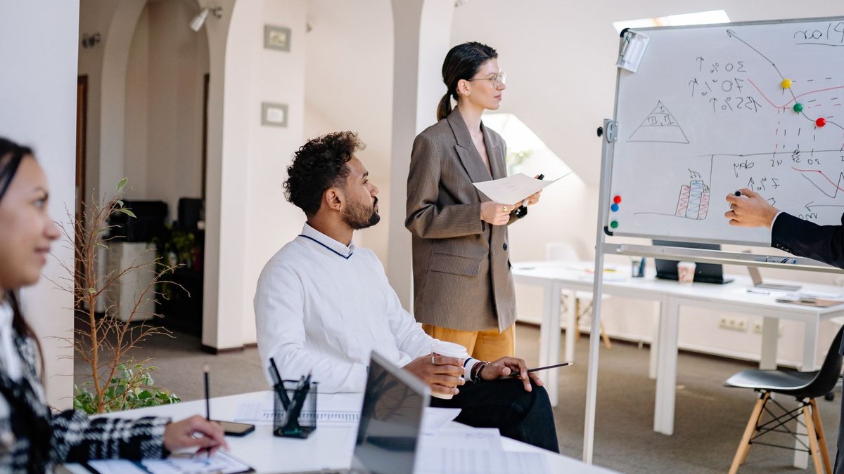 A diverse group of colleagues discussing ideas during a team meeting in a modern office setting.