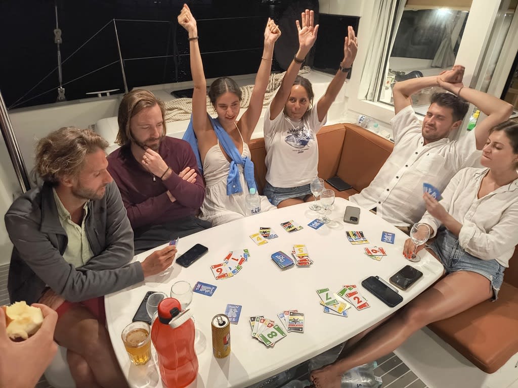 Friends enjoying playing cards on a sailing boat