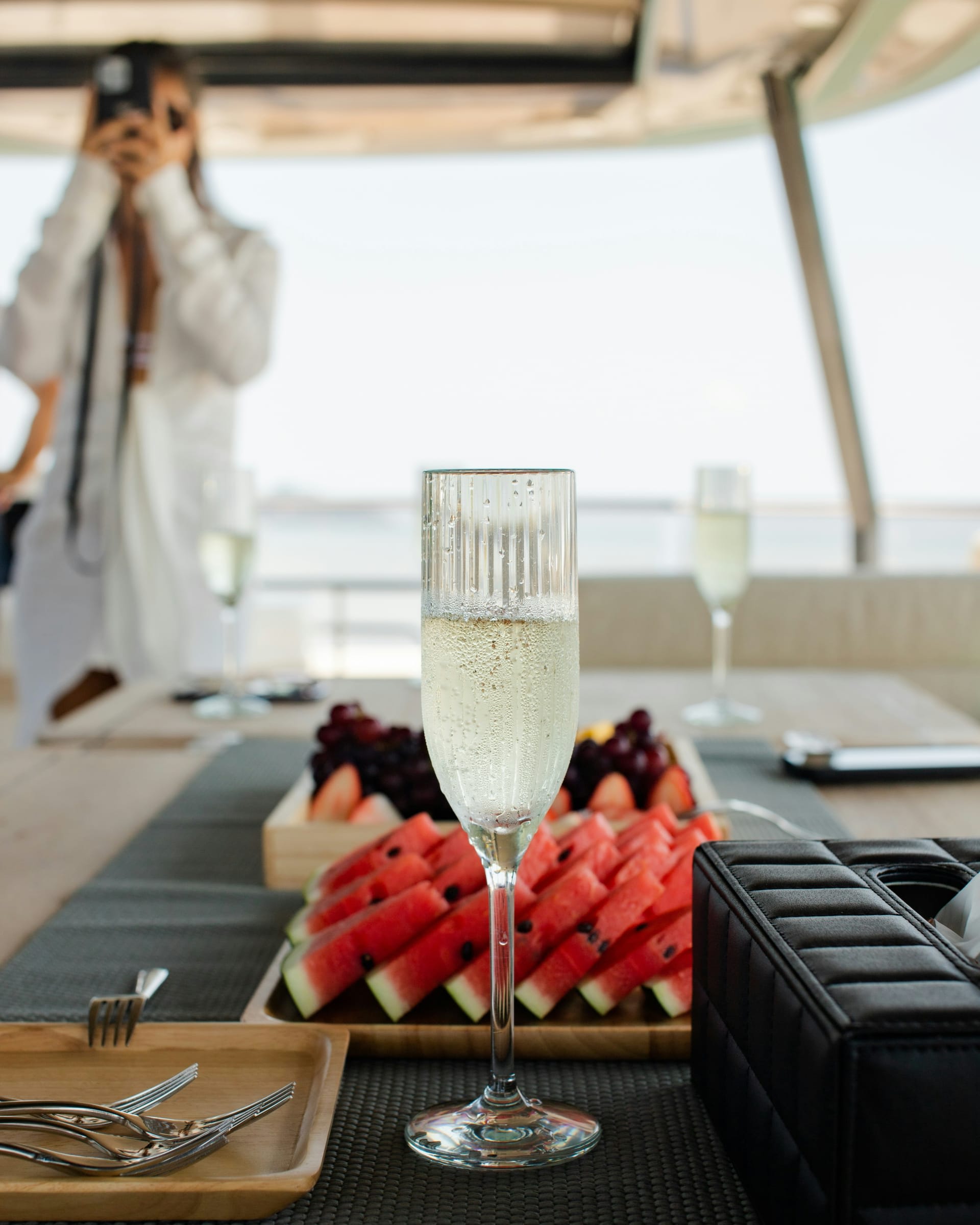 A group sharing a long lunch on deck