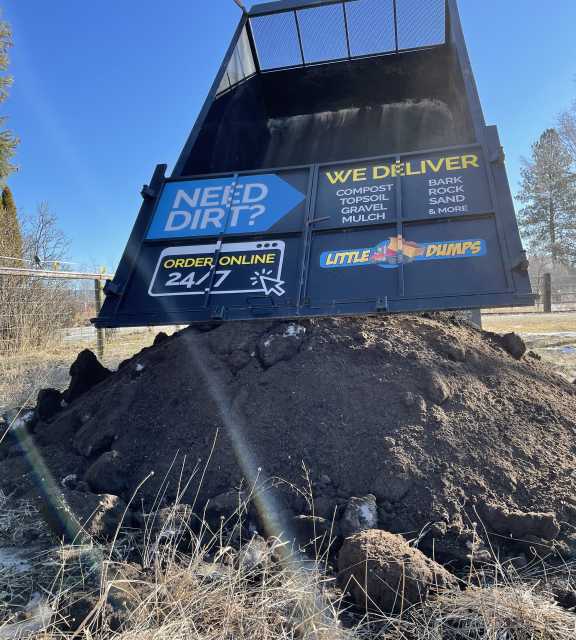 An image of a Little Dumps dump truck after dumping out a load of Compost.
