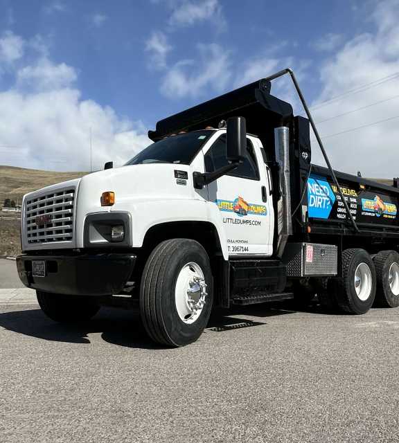 A photo of the large, 15-ton, Little Dumps dump truck in a sunny parking lot.