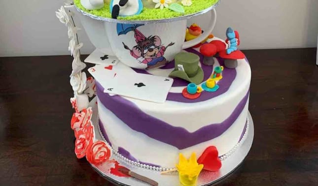 Floral birthday cake at Mad Hatter tea party at Cake International – The  Sugarcraft, Cake Decorating and Baking Show in London Stock Photo - Alamy