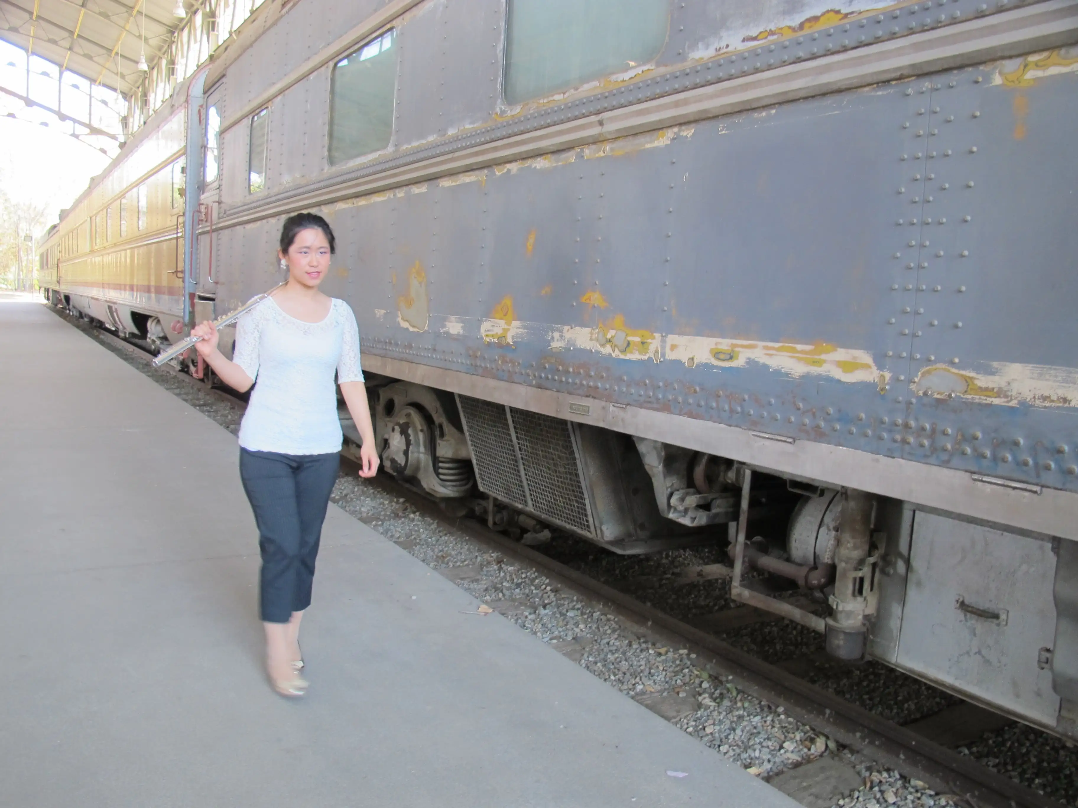 Weili walking alongside a train