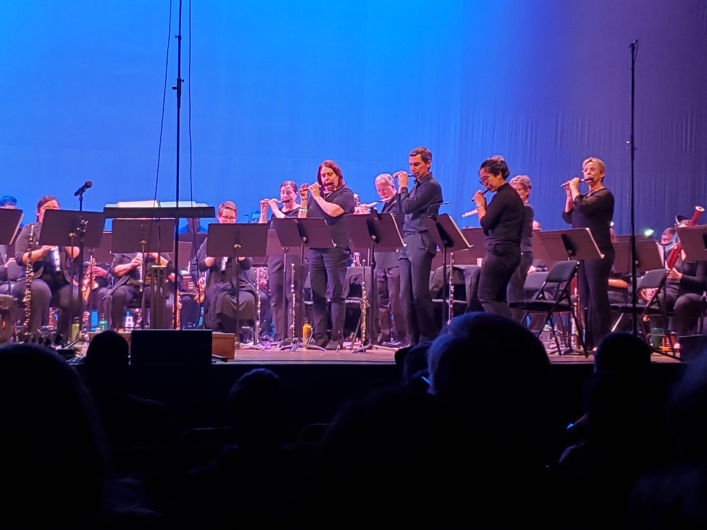 Weili playing the flute with other musicians