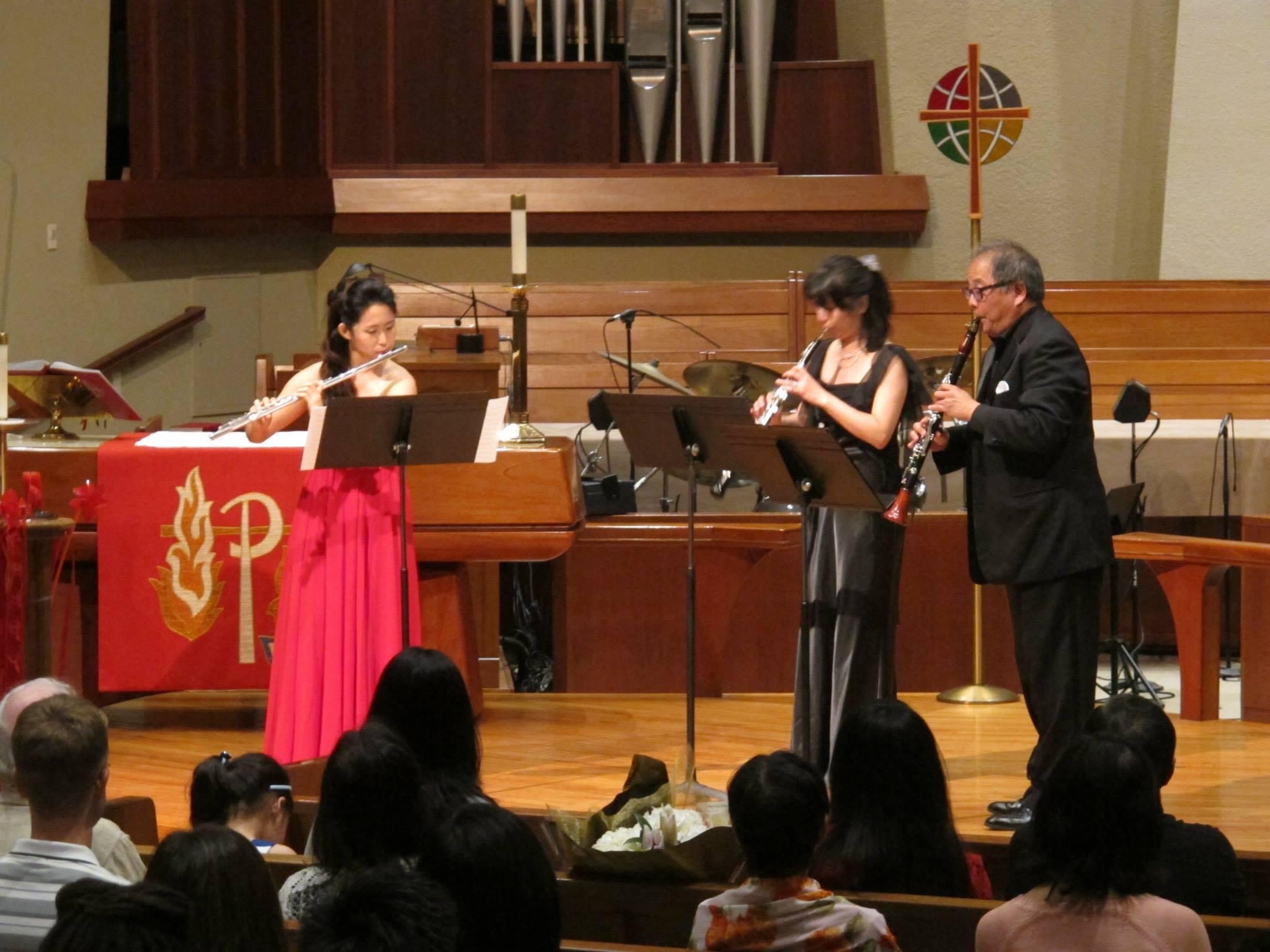Weili playing the flute with other musicians