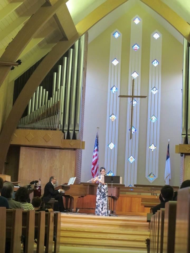 Weili playing the flute with a pianist