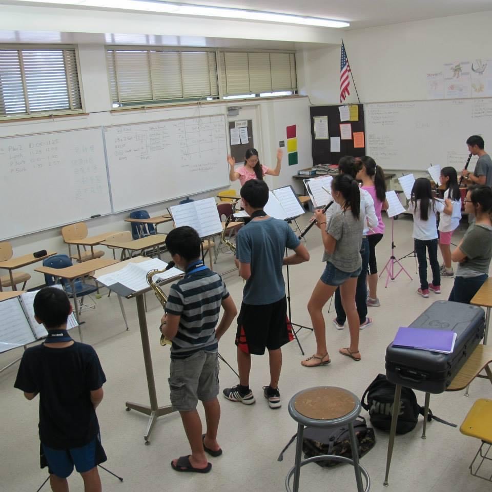 Weili teaching music class to students