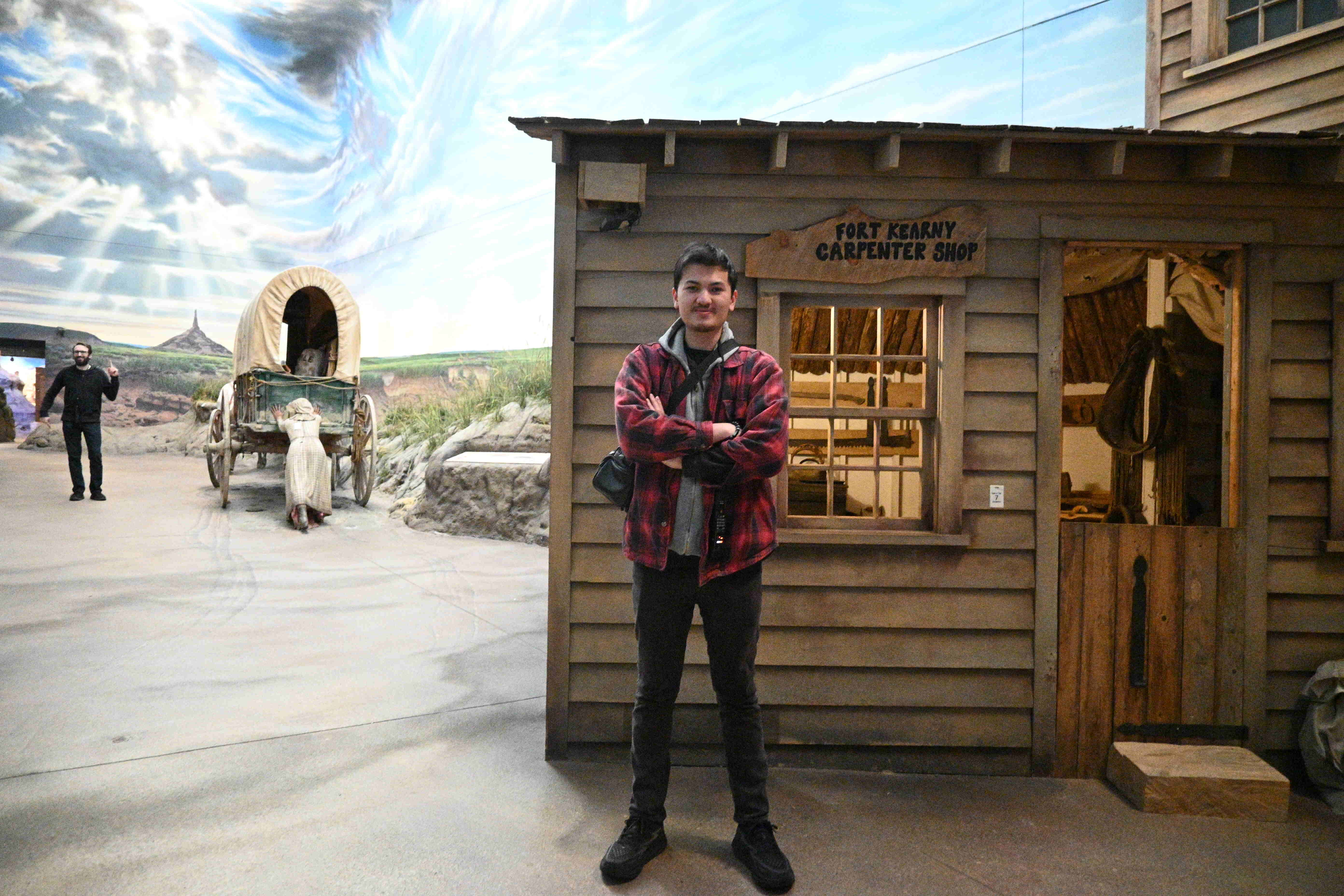 Brian posing in front of an exhibit