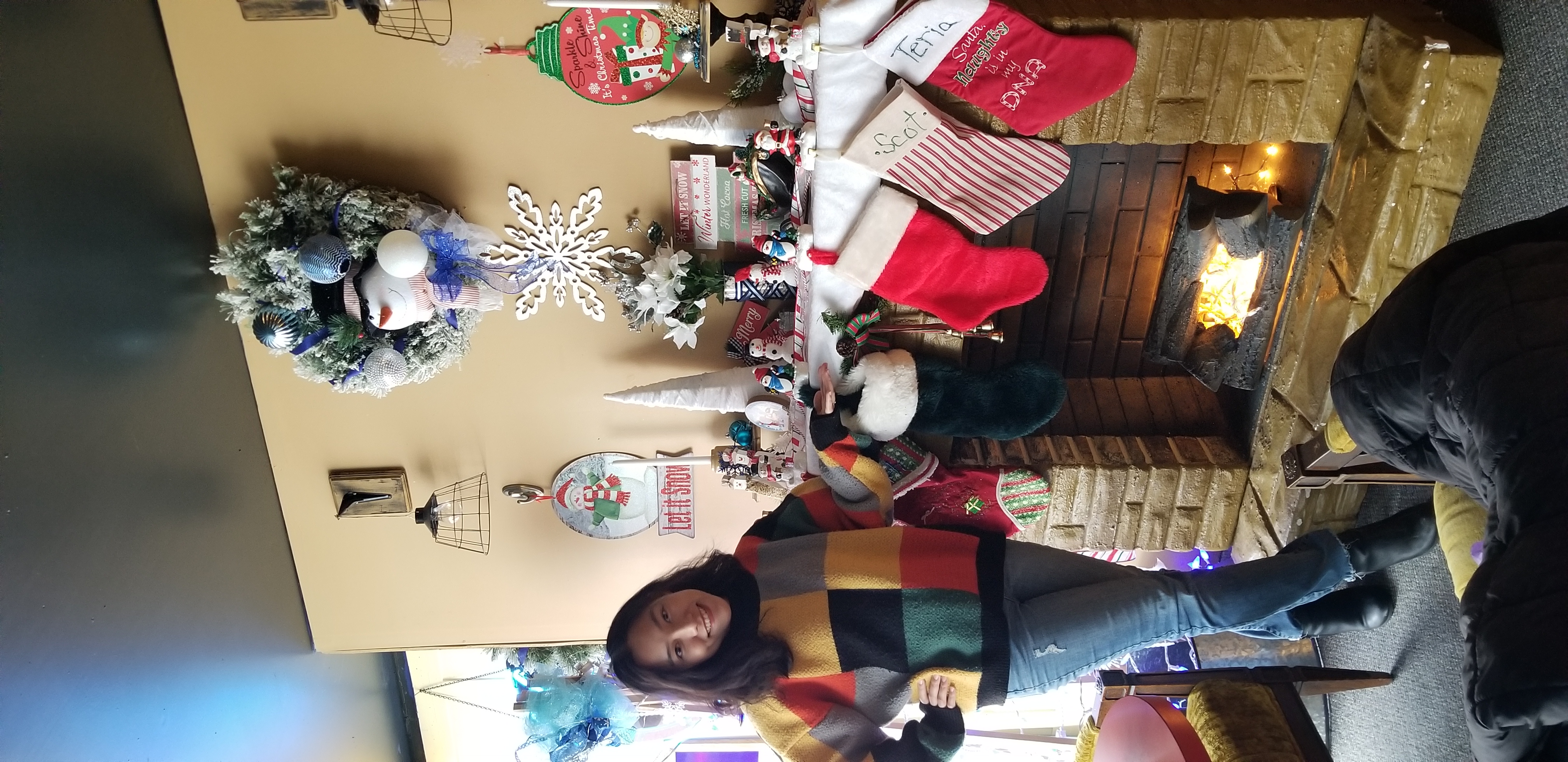 Thu posing in front of a fireplace inside of Blue Moon Coffee