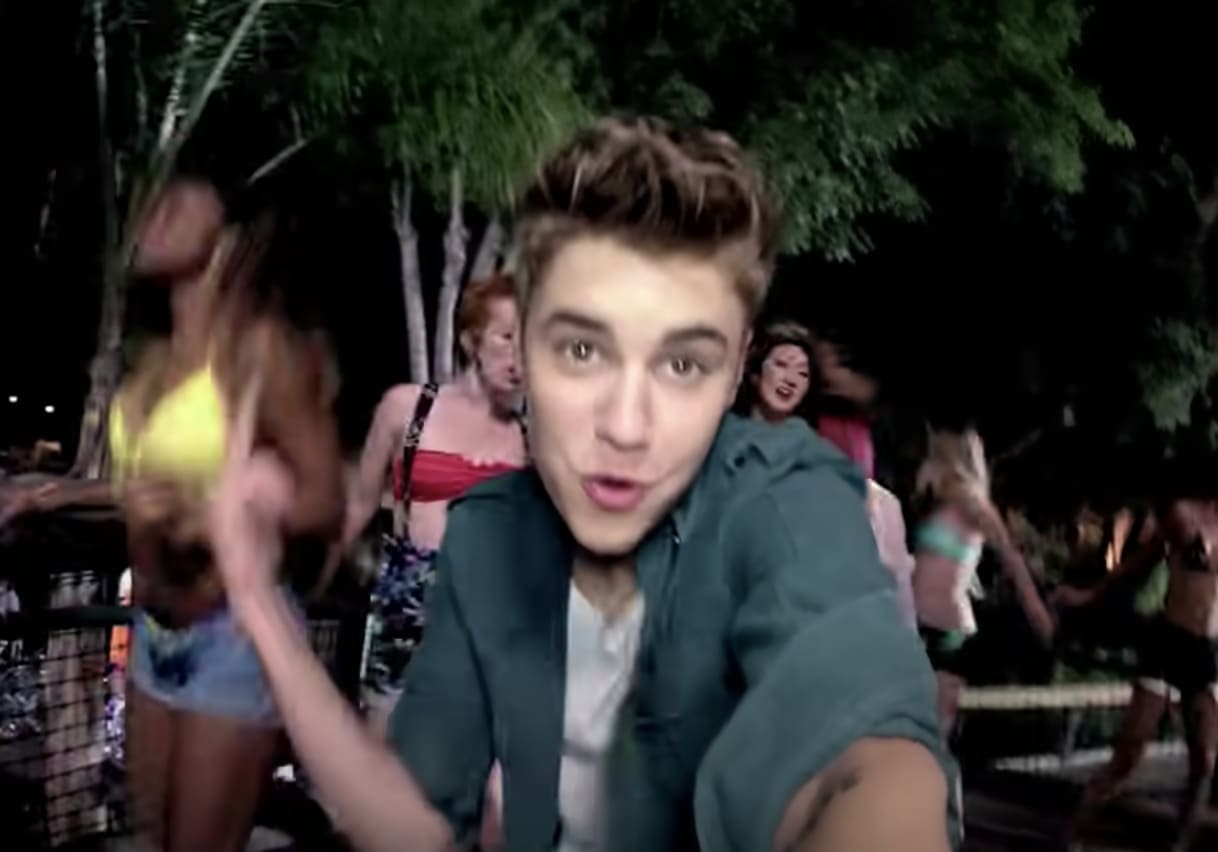 Justin dancing and singing into the camera in the music video