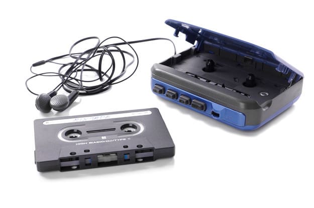 Old-fashioned music cassette and Walkman with earphones