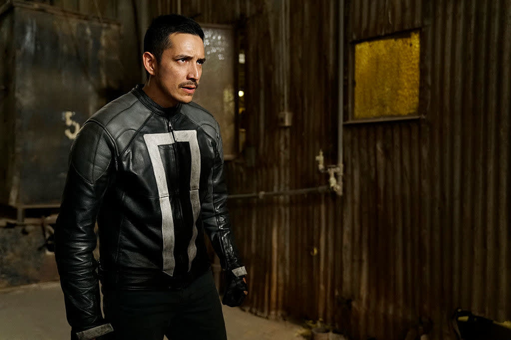 wearing his signature leather jacket, Robbie stands with his fists clenched, ready for a battle