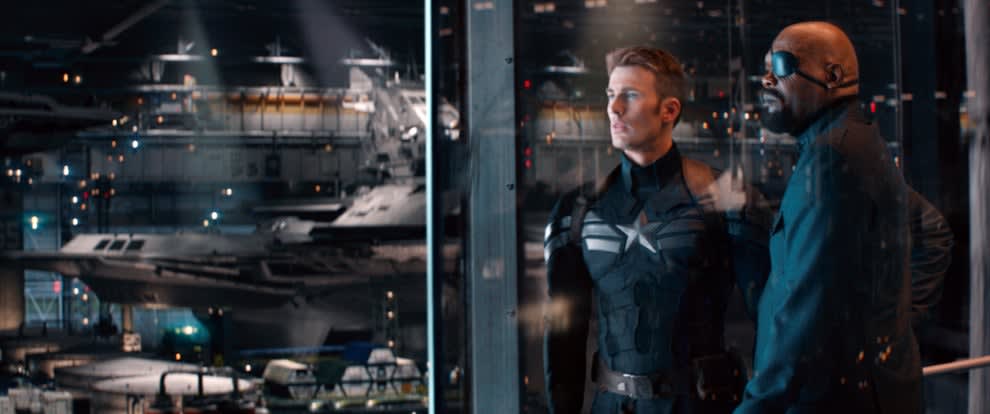 Captain America and Nick Fury look at SHIELD's collection of fighter jets