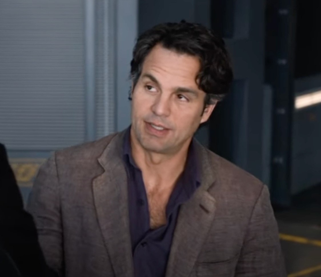 Bruce Banner is wearing a suit while looking up