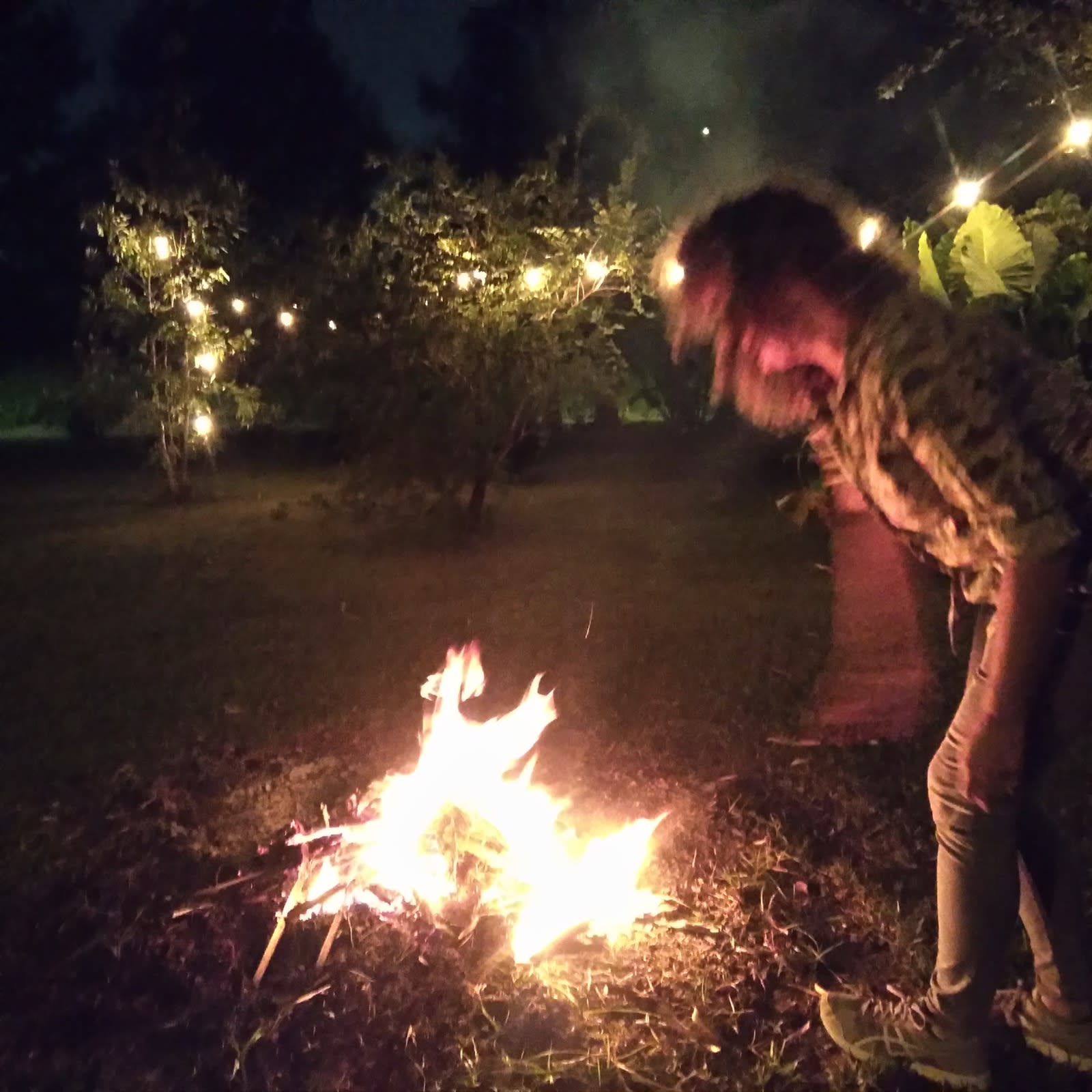 Gina puts leaves on a fire, New Orleans, October 23, 2021.