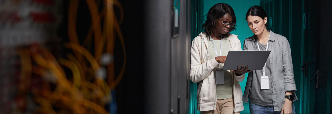 wide-angle-portrait-two-young-women-using-laptop-server-room-while-setting-up-supercomputer-network-copy-space.jpg