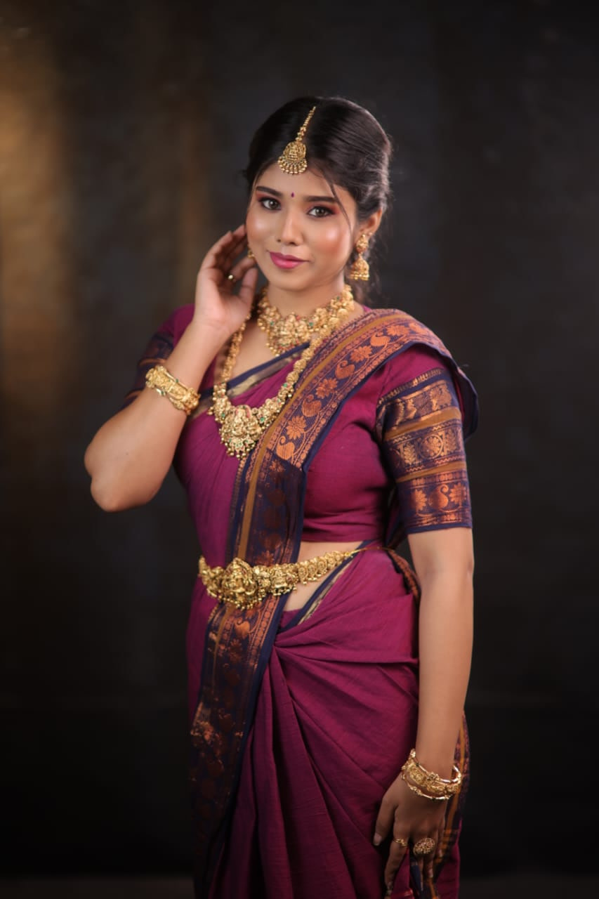 Mother-of-the-bride look in a magenta silk saree with layered gold temple jewellery, done at home in Chennai