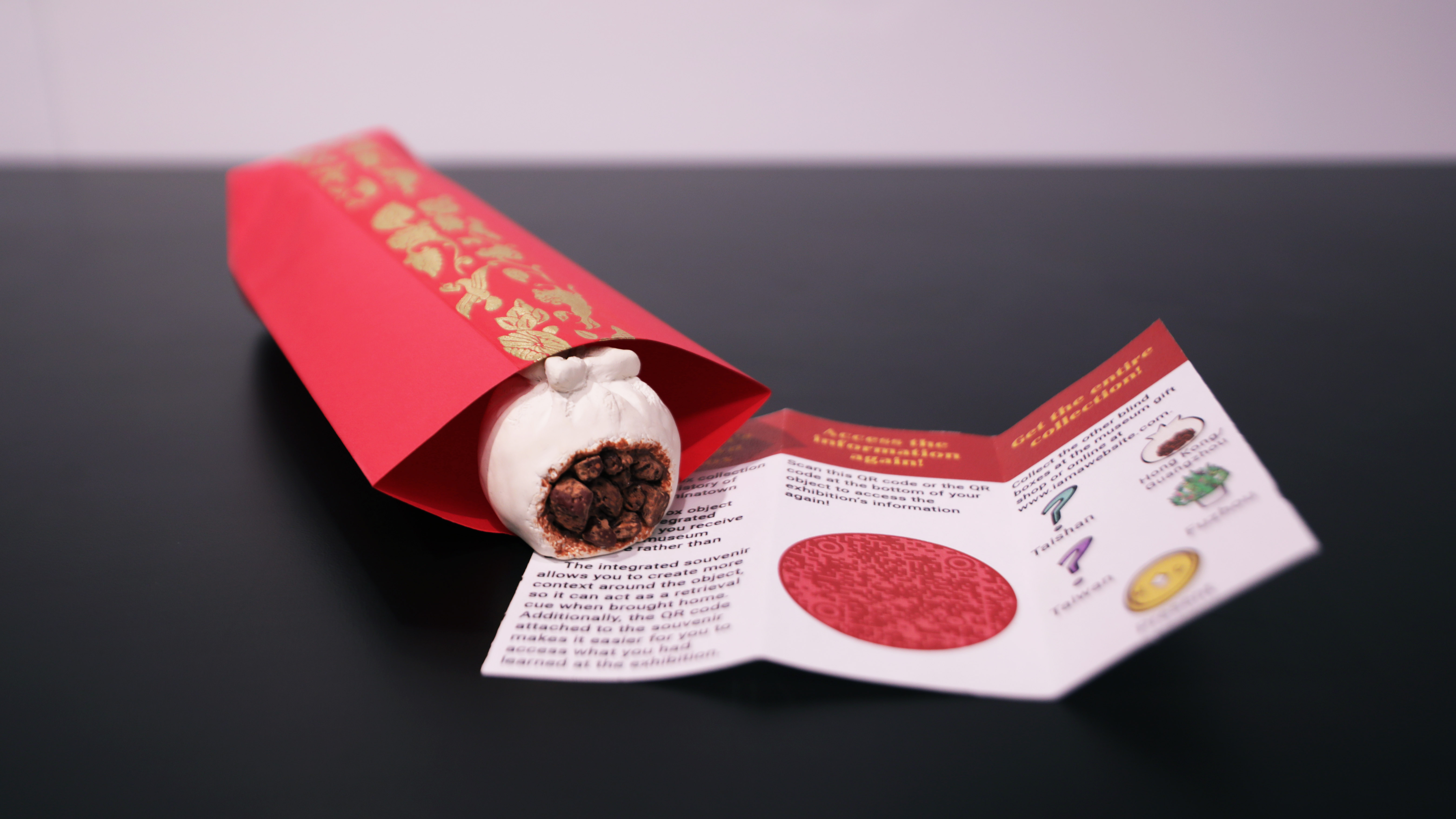 Close up of blind box package with pork bun souvenir and pamphlet