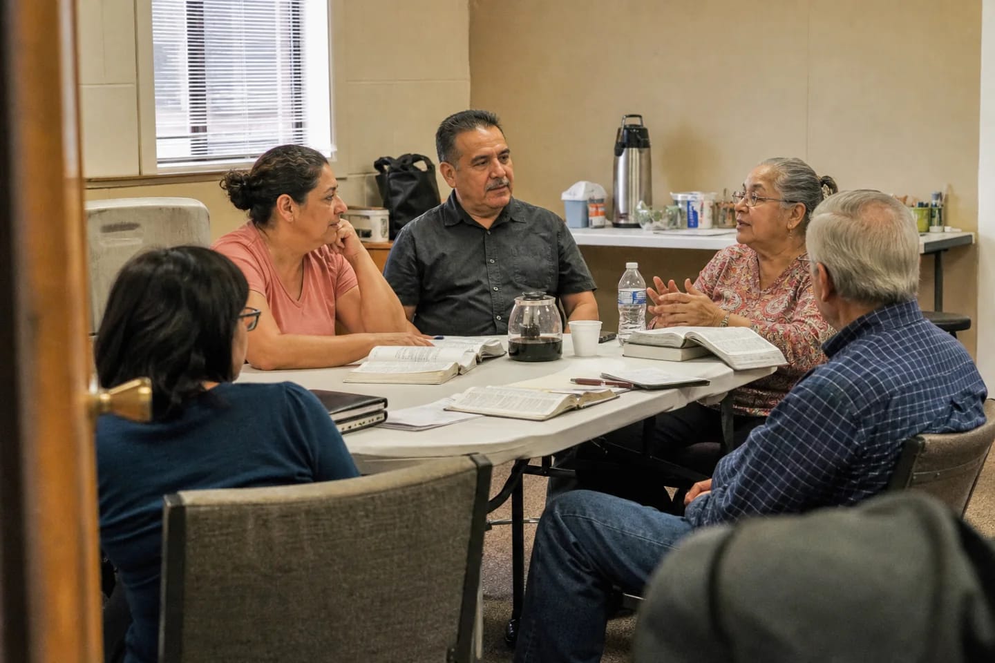 Adults gathered for Bible study and conversation in a church classroom