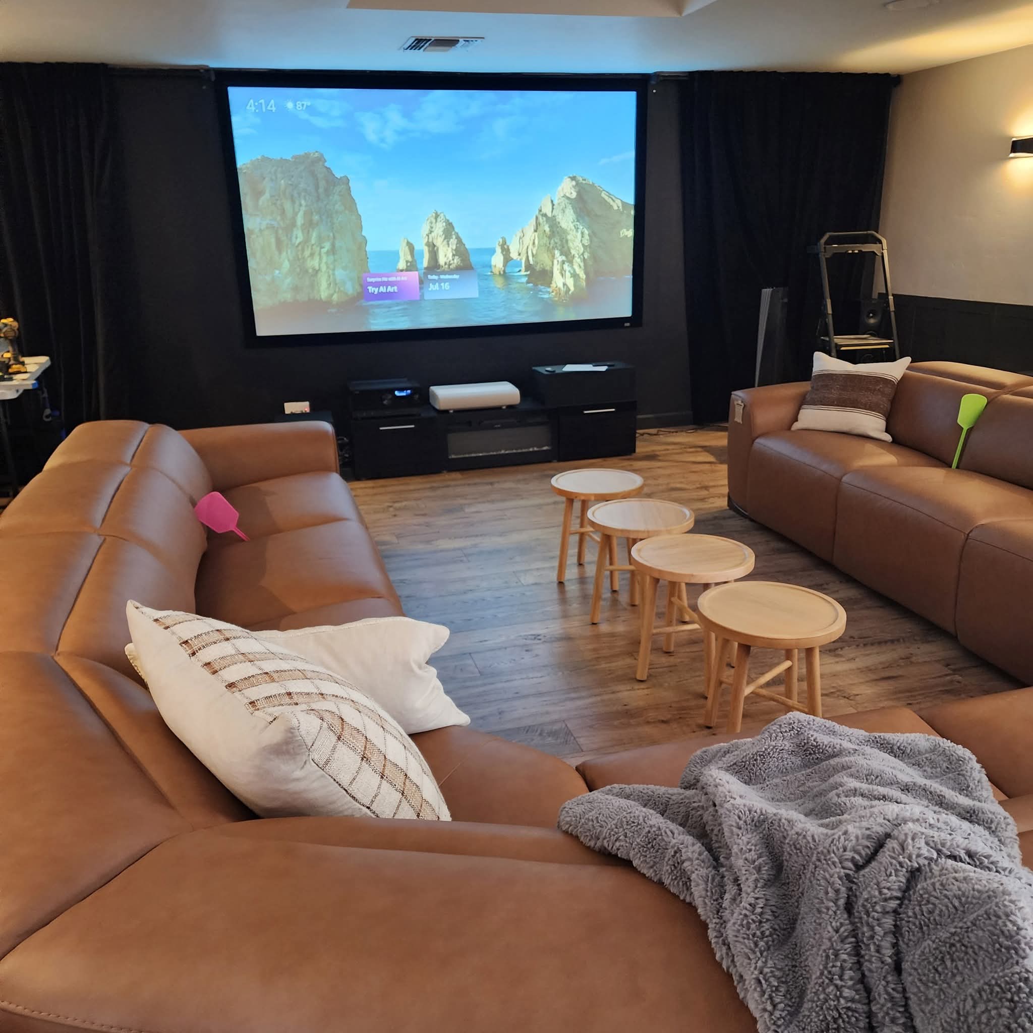 Johnston's Custom Home Theater finished theater with projection screen and tan couches