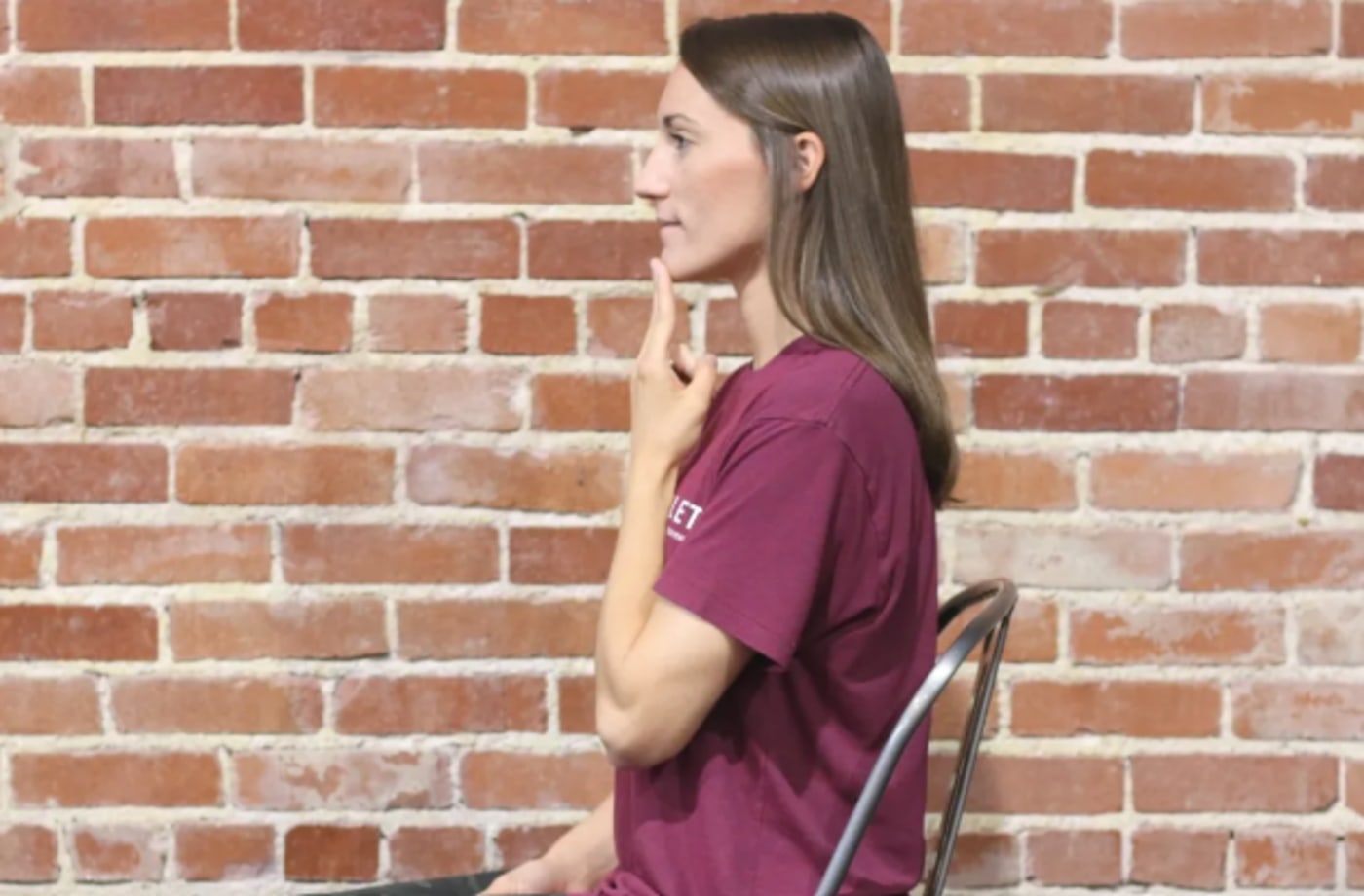 Woman touching her chin with 2 fingers