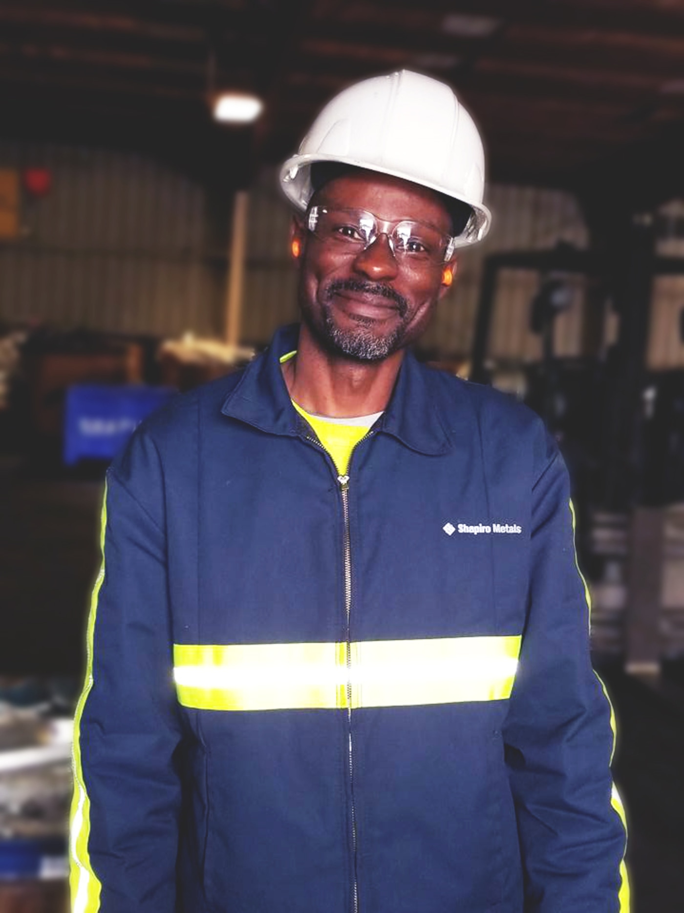 Man in hard hat and blue zip up