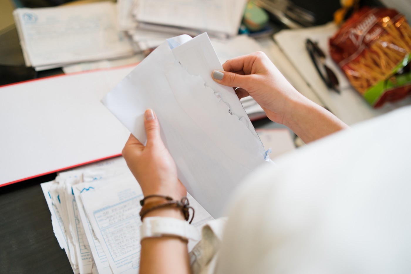 Woman opening envelopes