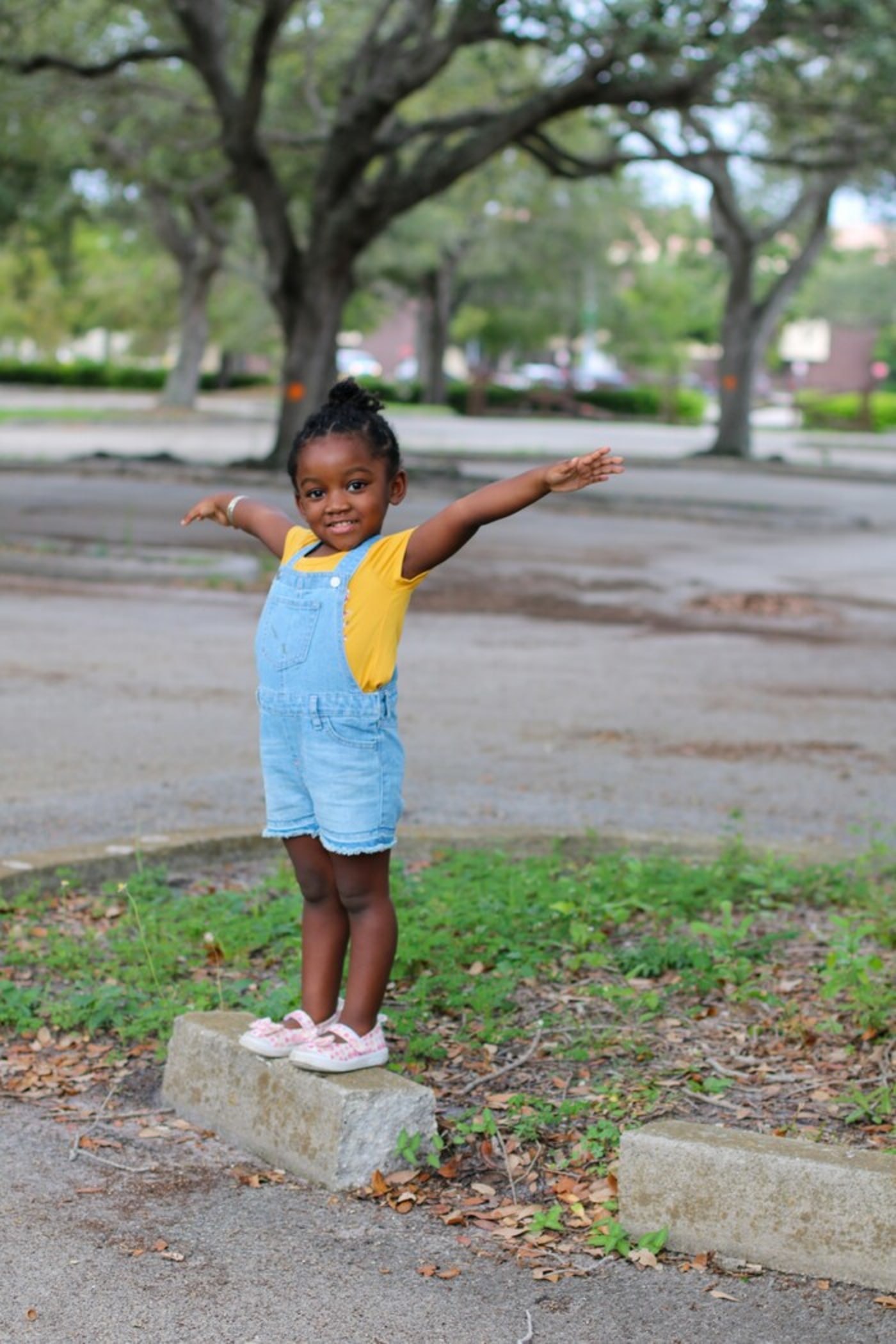 A happy toddler posing outside