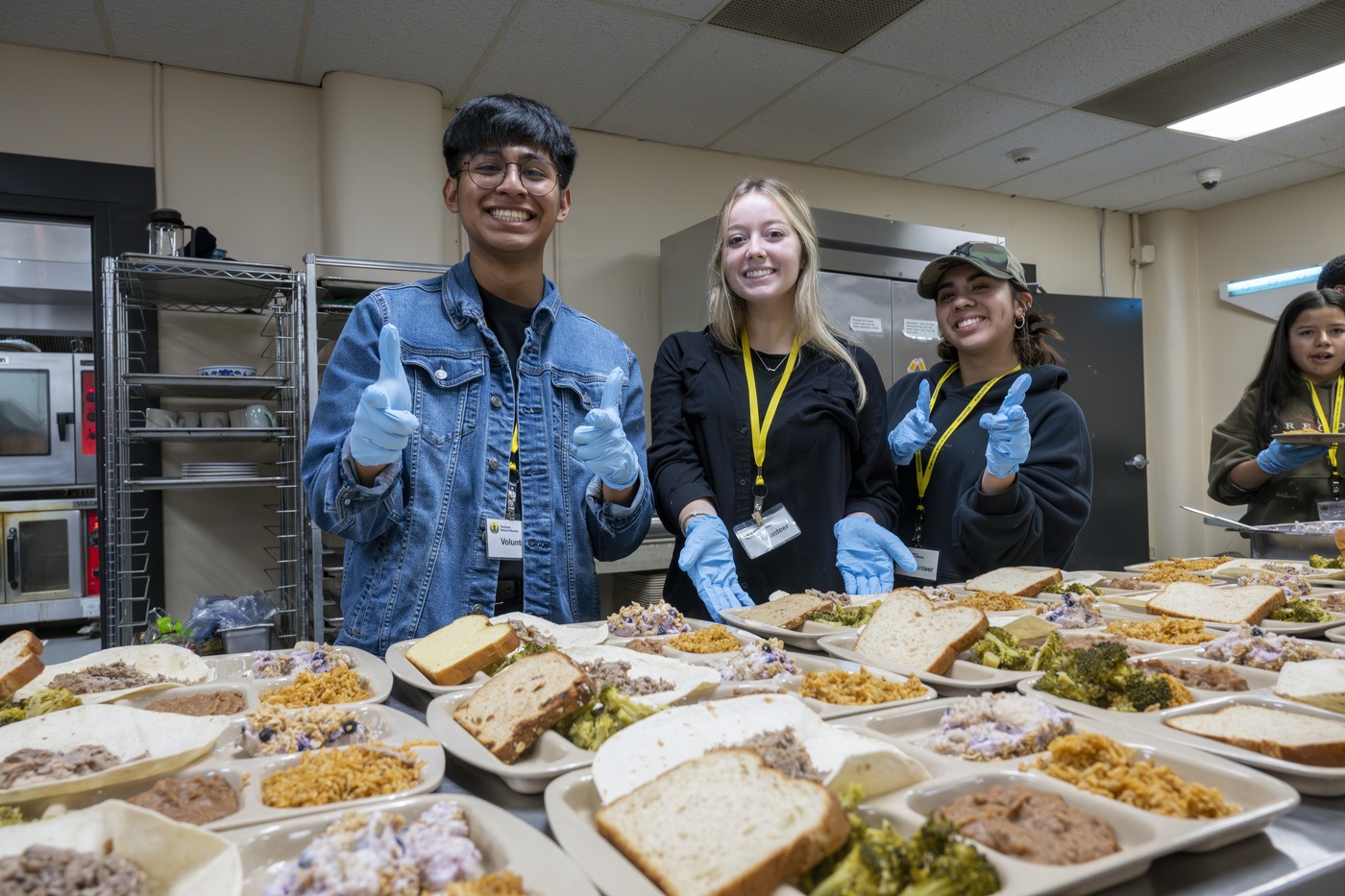 Young adults volunteering to serve food to the needy