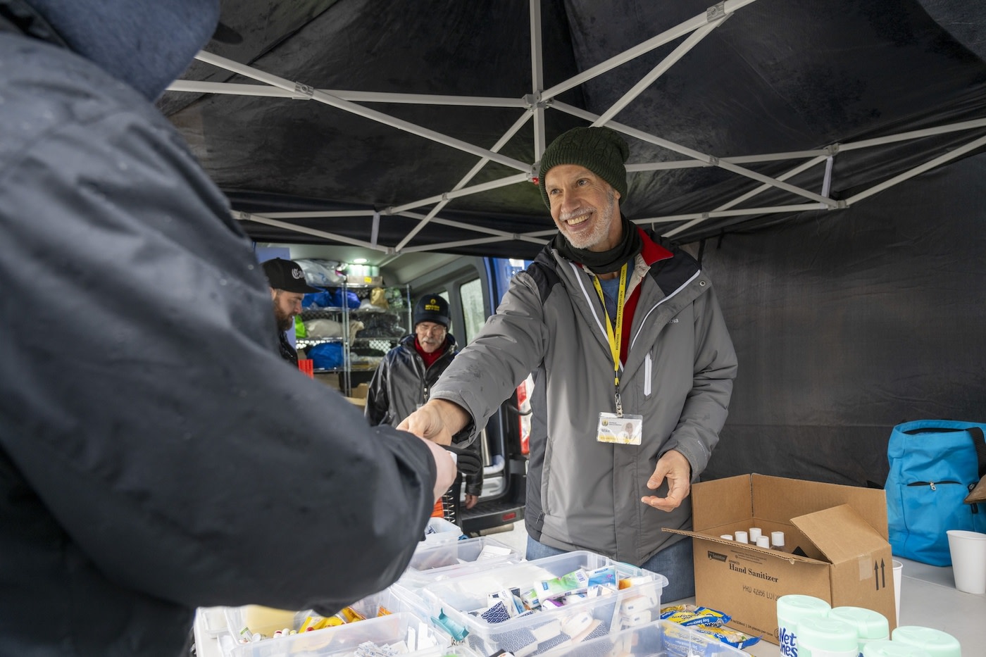 Volunteer giving an item to someone else