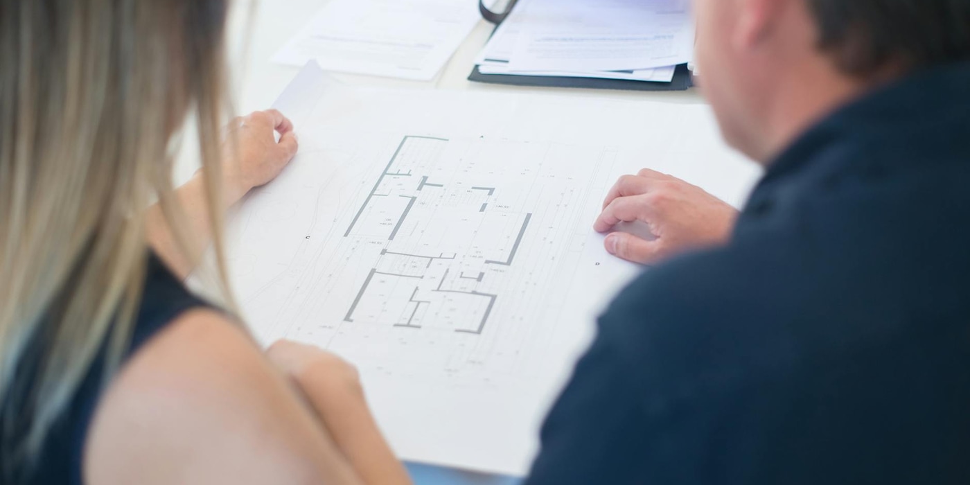 Woman and man looking at floor plans
