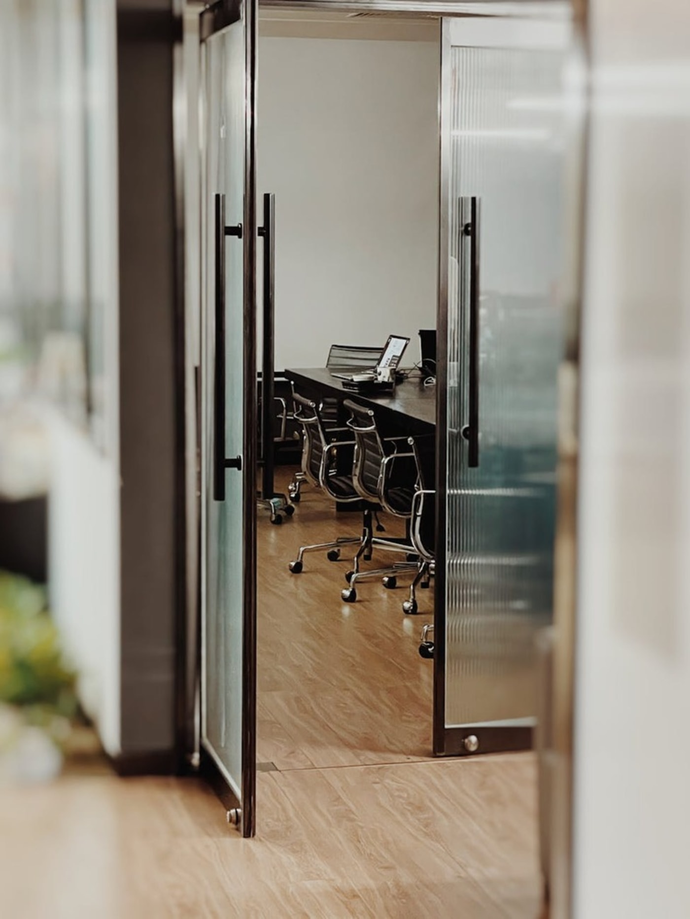 Commercial building open glass door leading into a conference room