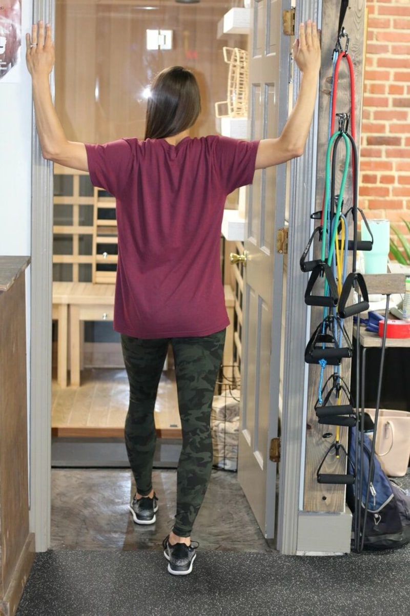 Woman with Back facing you and hands on wall