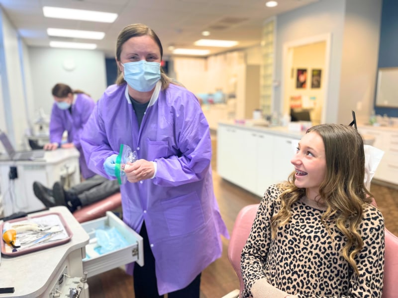 Assistant and patient getting braces