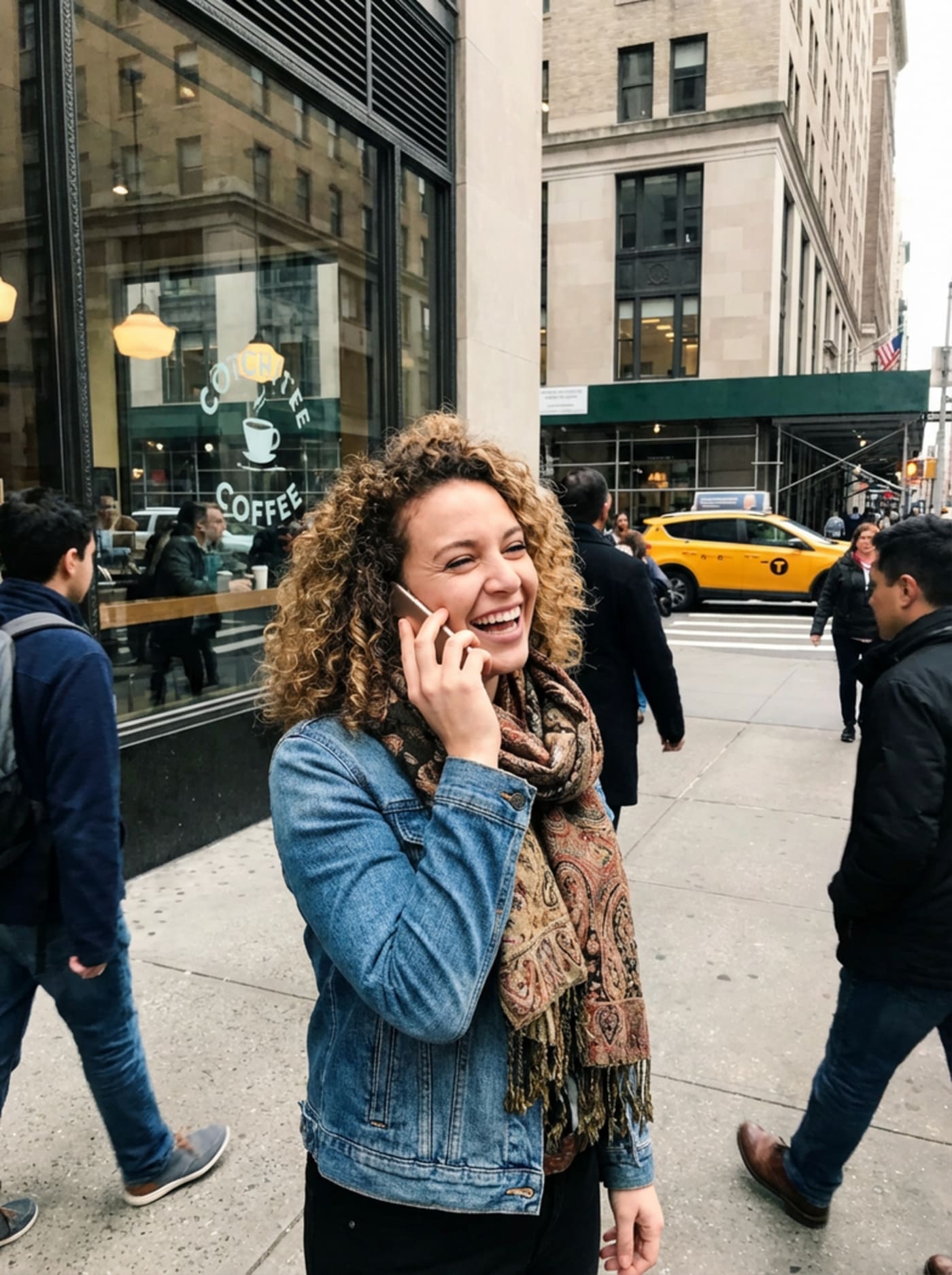 Woman standing outside on a busy sidewalk talking on the phone