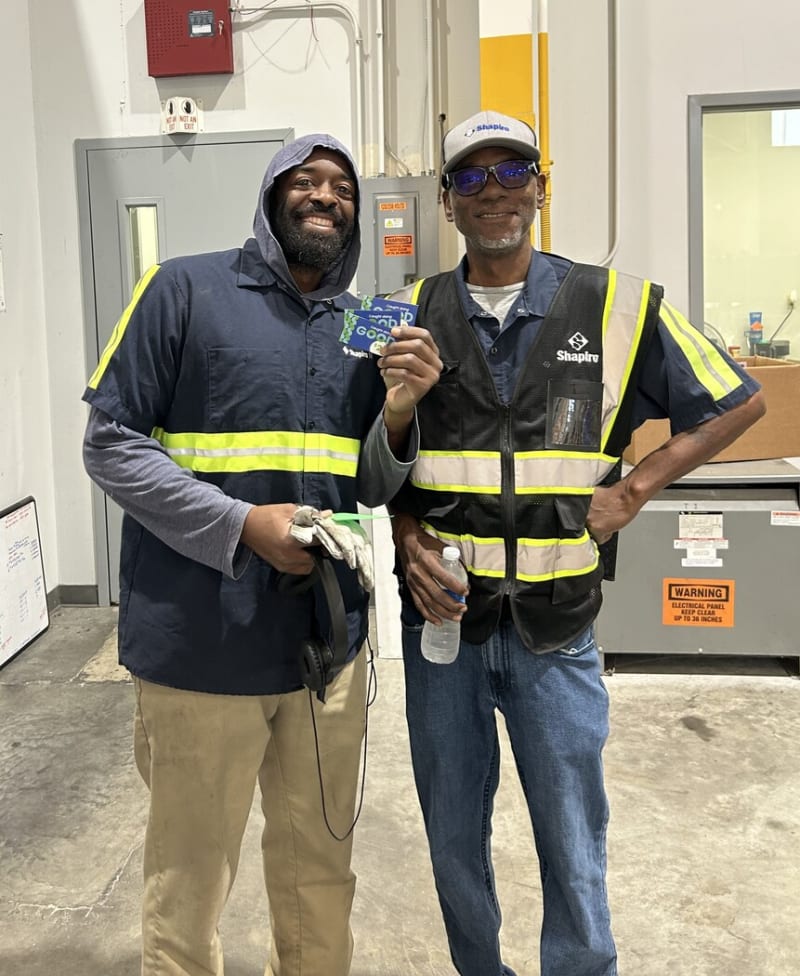Two men posing with safety gear on
