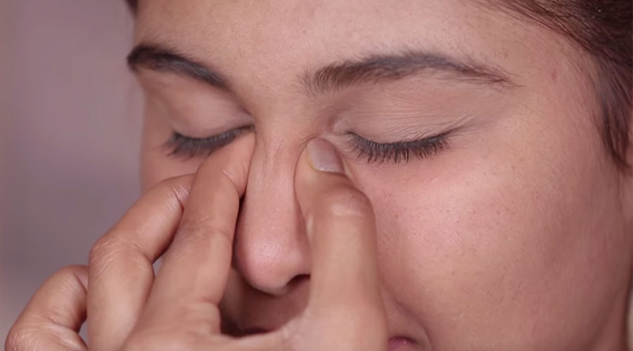 Gently pinch your nose from the tip all the way to the center of your forehead. Repeat the process 3 or 4 times.