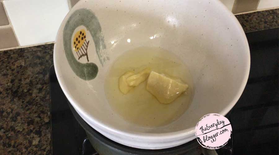 Gently melt shea butter and coconut oil on top of a double boiler or Bain Marie. Remove from heat and let it cool down a bit.