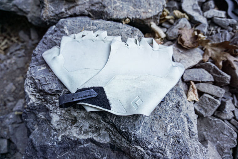 Black Diamond crack gloves resting on a stone