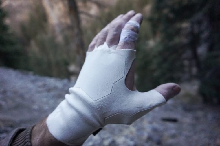 Black Diamond crack gloves on, highlighting the synthetic suede material